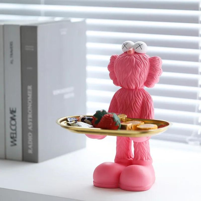 Elegant Nordic resin doll with tray in a bright living room setting.