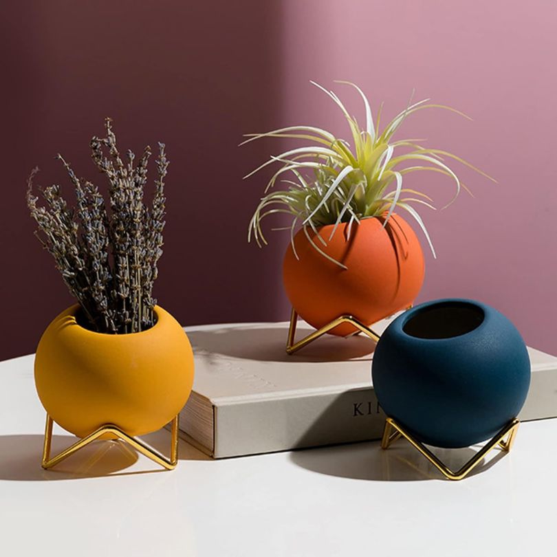 Nordic round pottery floral vase in royal blue with metal stand, perfect for home decor.