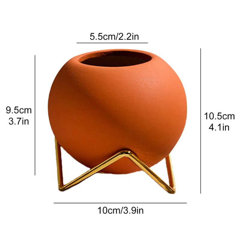 Burnt orange floral vase with metal stand, ideal for displaying fresh flowers in any setting.