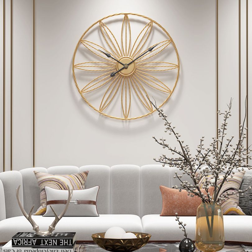 Close-up view of the decorative wall clock with silent movement highlighting its modern gold finish.