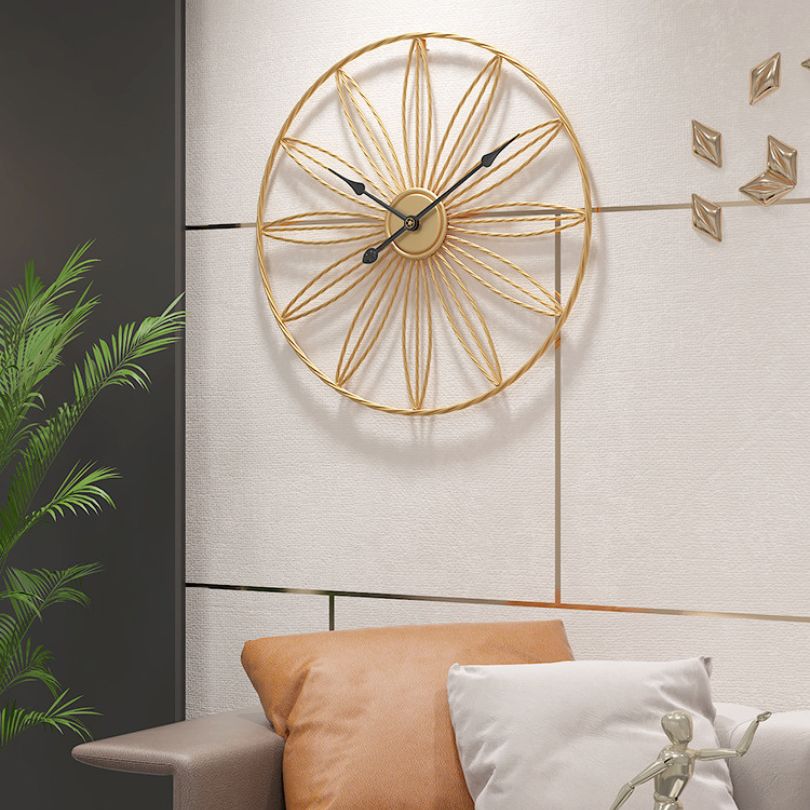 Close-up view of the decorative wall clock with silent movement highlighting its modern gold finish.