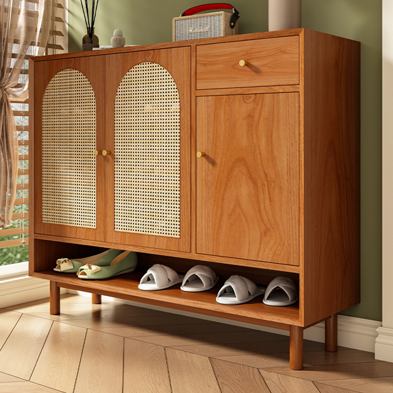 Close-up of adjustable shelves inside the Nordic rattan shoe cabinet.