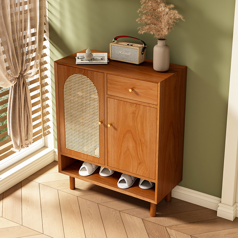 Close-up of adjustable shelves inside the Nordic rattan shoe cabinet.