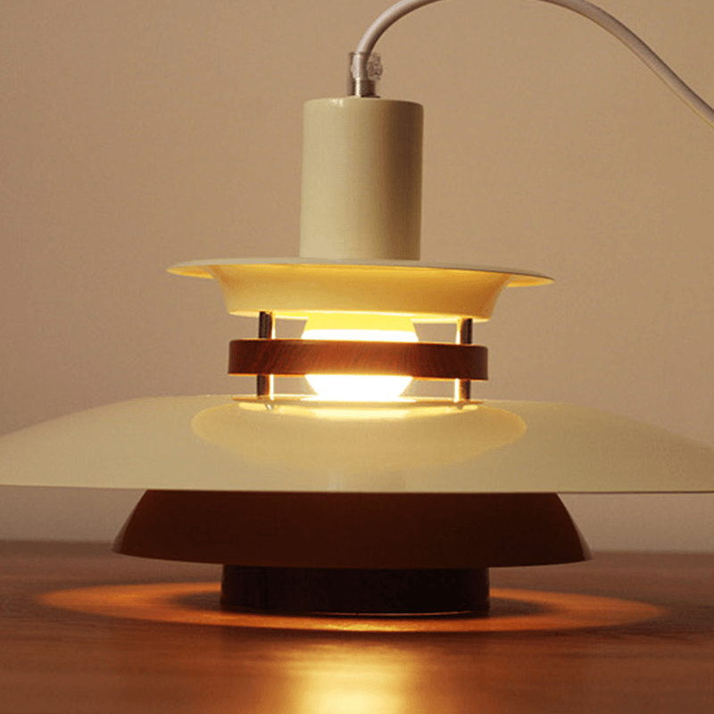Elegant Nordic PH5 Pendant Lamp hanging in a cozy cafe, showcasing its stylish aluminum and wood design.