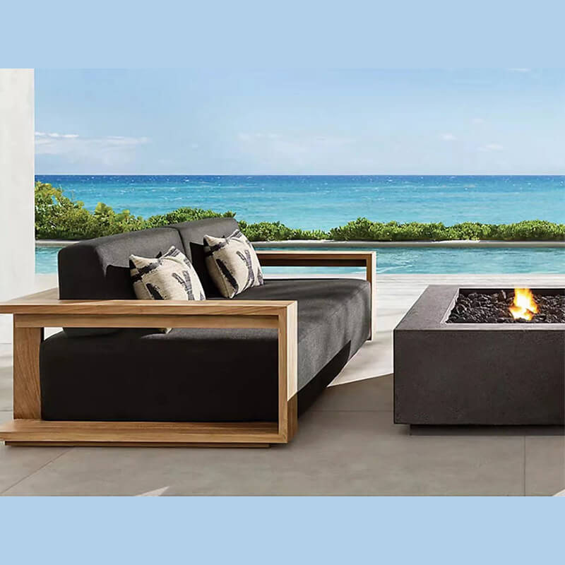 Angled view of Nordic teak wood furniture set styled on patio with soft cushions