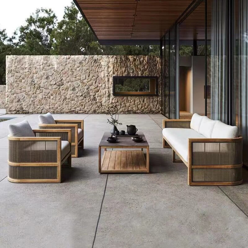 Front view of the Nordic rattan patio conversational set highlighting its U-shaped design and teakwood accents.