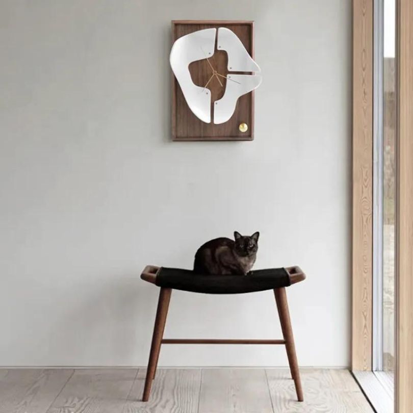 Close-up of the minimalist design of the walnut wood clock, highlighting its sleek finish.