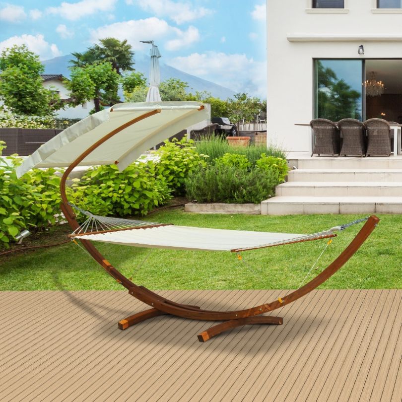 Nordic wooden arc hammock bed with canopy under sunlight.