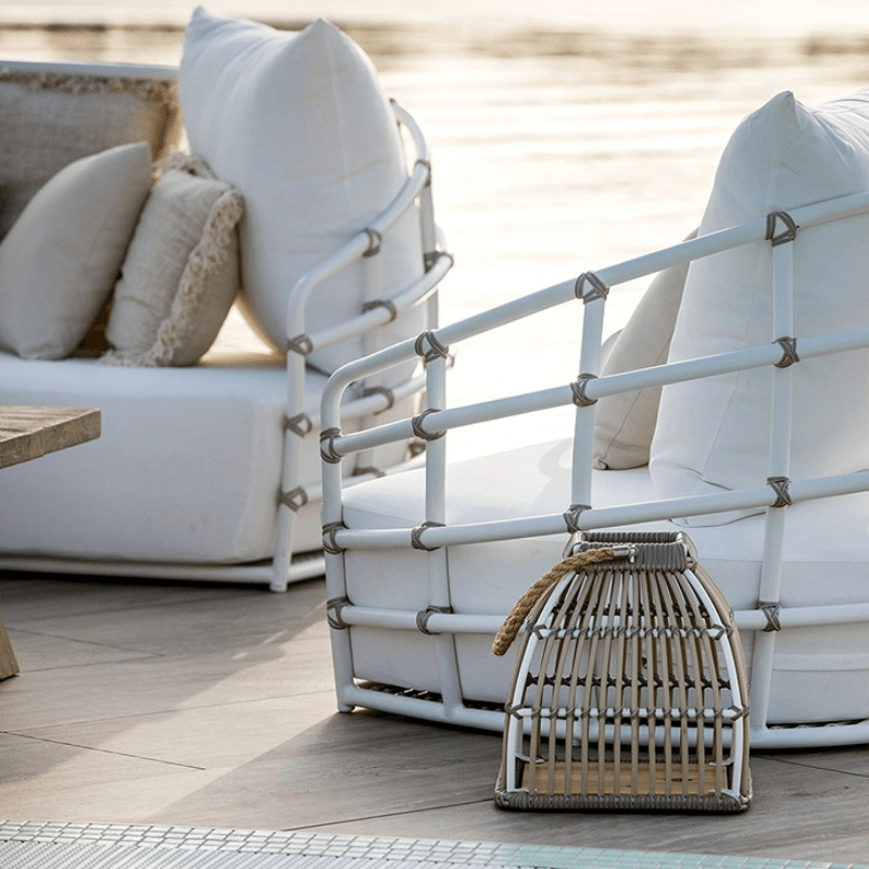 Outdoor sectional rattan daybed sofa with plush cushions and aluminum frame, ideal for backyard relaxation.