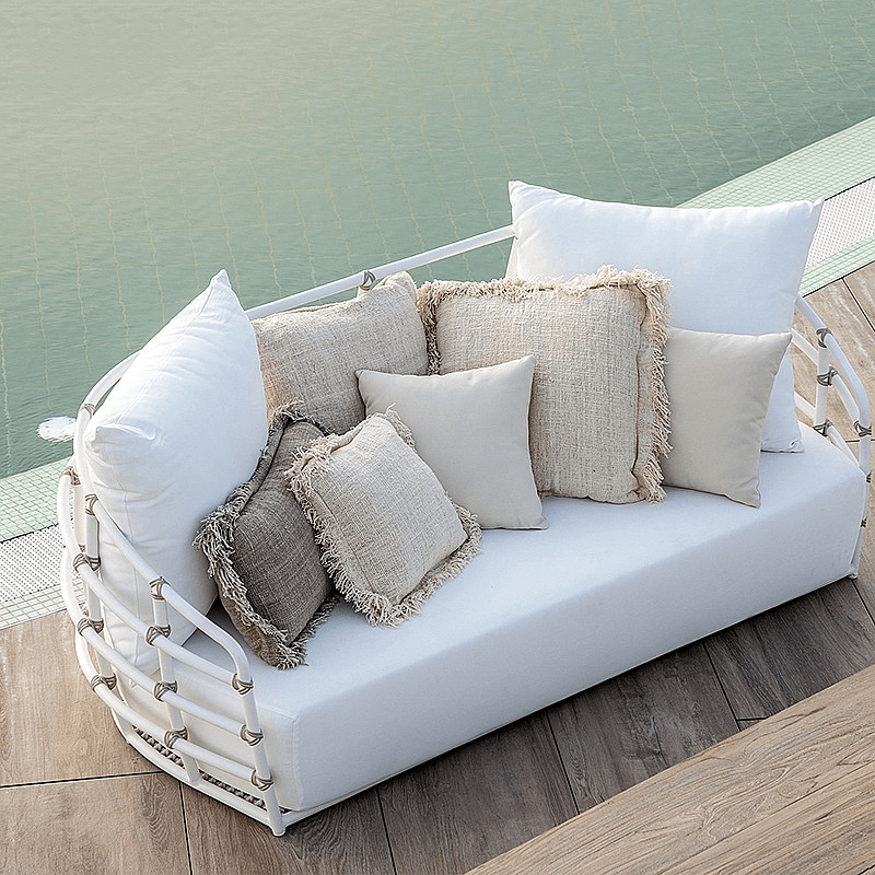 Outdoor sectional rattan daybed sofa with plush cushions and aluminum frame, ideal for backyard relaxation.