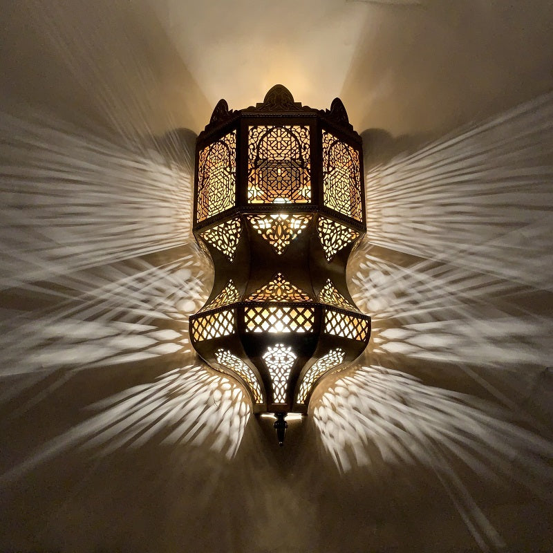 The Moroccan lamp illuminating a stylish dining room, highlighting its warm glow.
