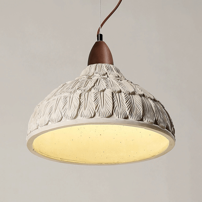 Close-up of industrial concrete hanging lamp for kitchen island showcasing the beige and brown finish.