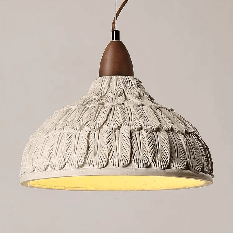 Rustic concrete pendant light with wood accent, hanging in a restaurant environment.