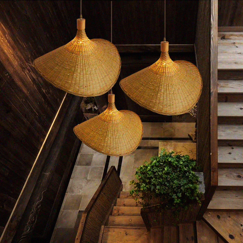 Bamboo pendant light hanging over a dining table, creating an inviting atmosphere.