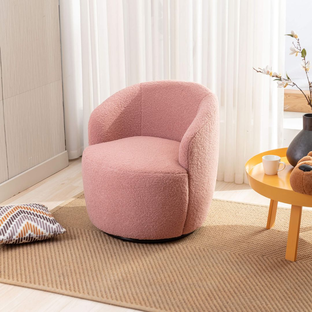Side angle of pink swivel teddy accent chair emphasizing the black powder-coated base.