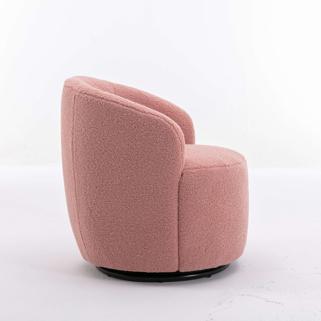 Lifestyle shot of pink barrel chair with black base in a cozy living room setting.