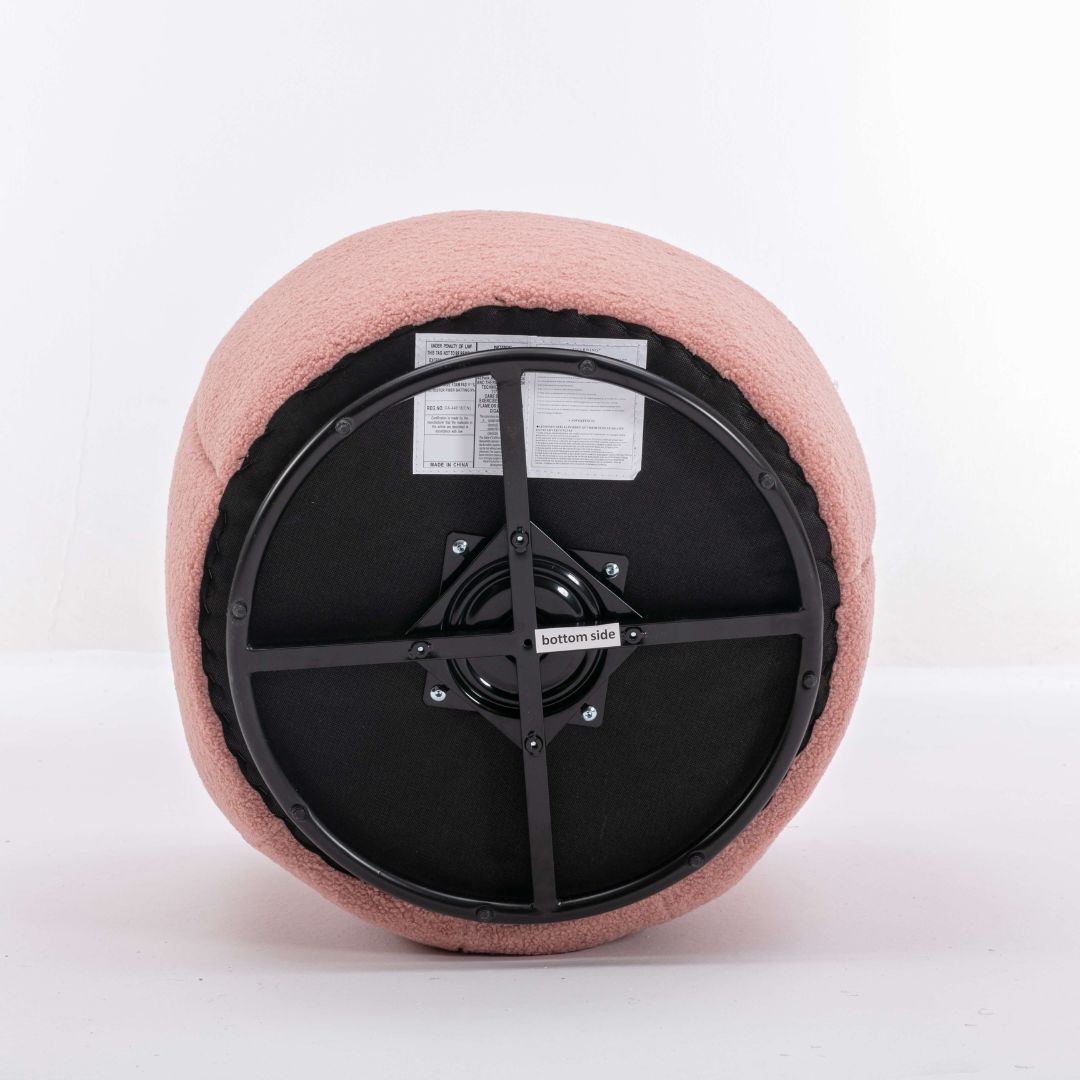Side angle of pink swivel teddy accent chair emphasizing the black powder-coated base.