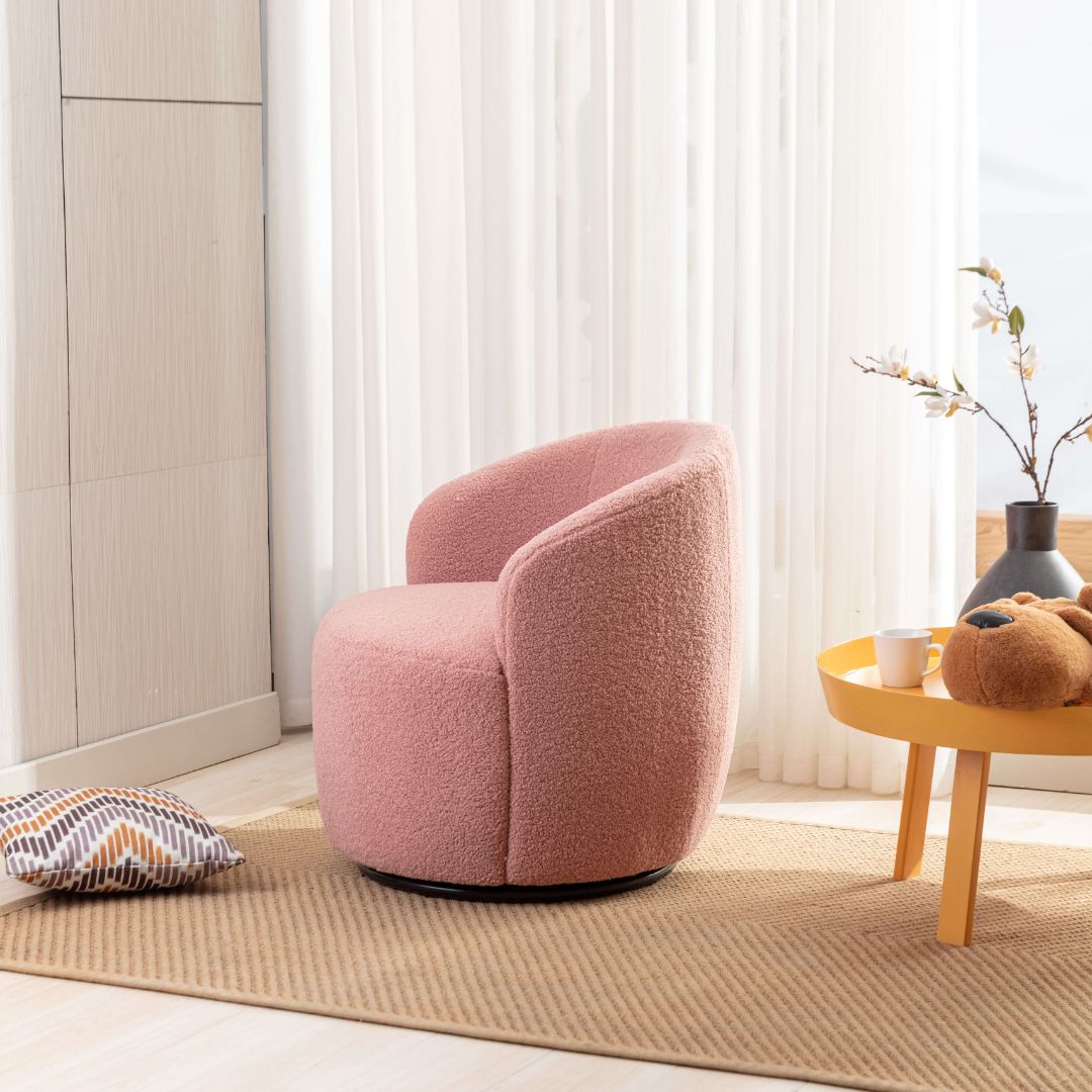 Lifestyle shot of pink barrel chair with black base in a cozy living room setting.