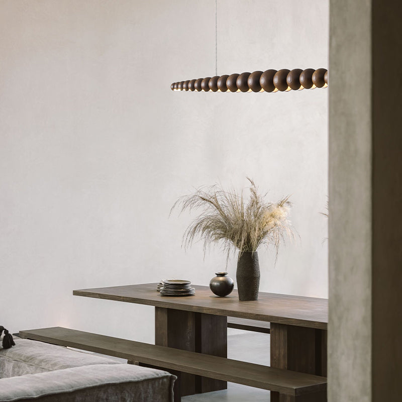 Front view of the elegant wooden LED pendant light in a modern kitchen setting.