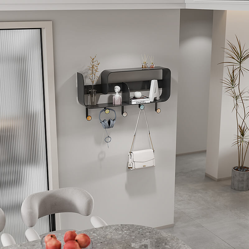 Angle view of wall-mounted hooks with storage shelf installed in a hallway