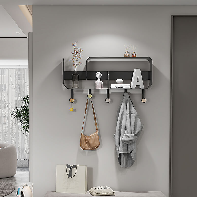Angle view of wall-mounted hooks with storage shelf installed in a hallway