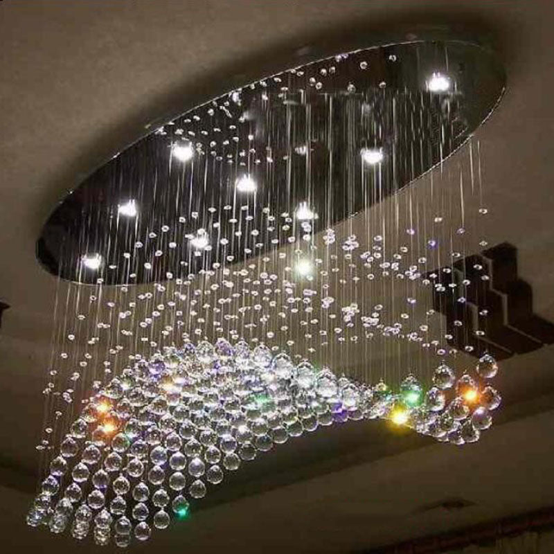 Elegant teardrop crystal flush mount light illuminating a cozy living room