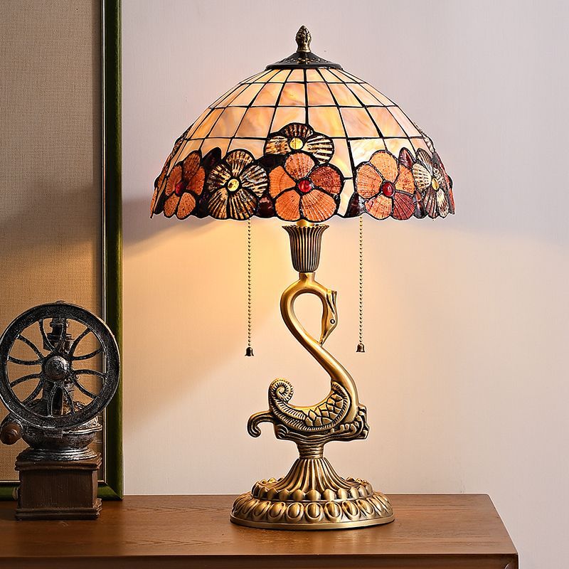 Close-up of the swan brass lamp highlighting the clear glass shade and intricate details.