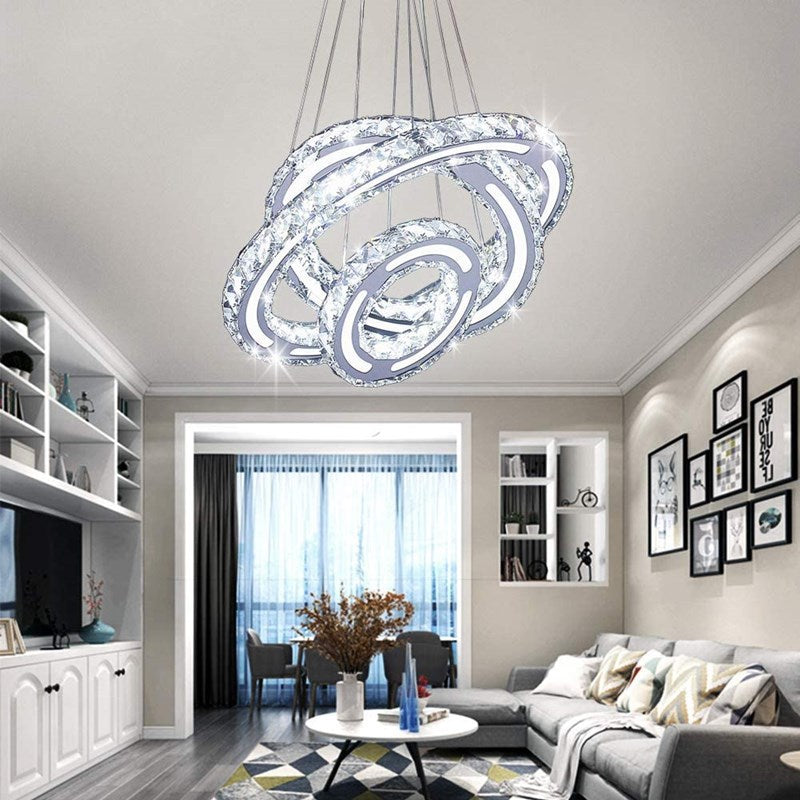 Elegant 3-ring crystal LED pendant light in a contemporary dining room setting.