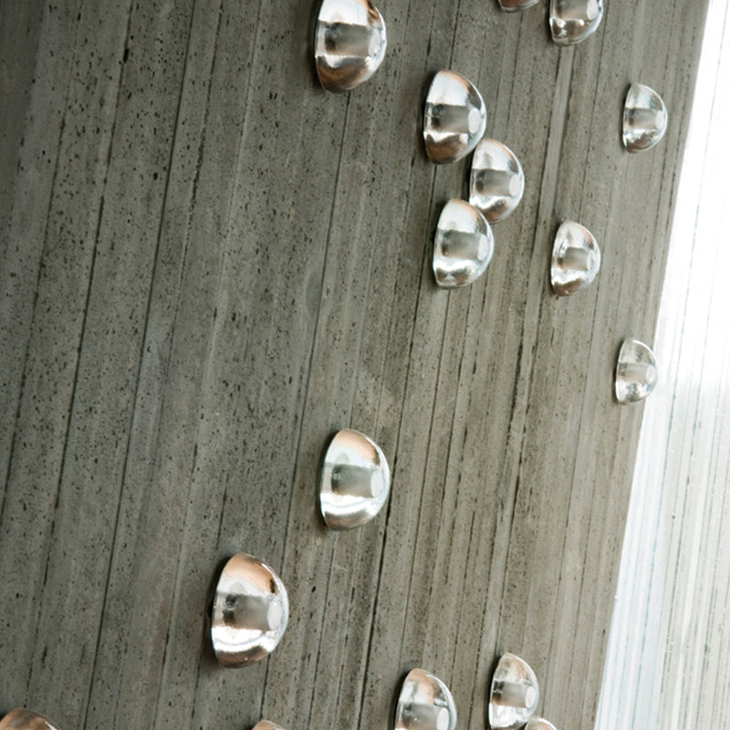 Outdoor view of the wall lamp illuminating a garden entrance at dusk