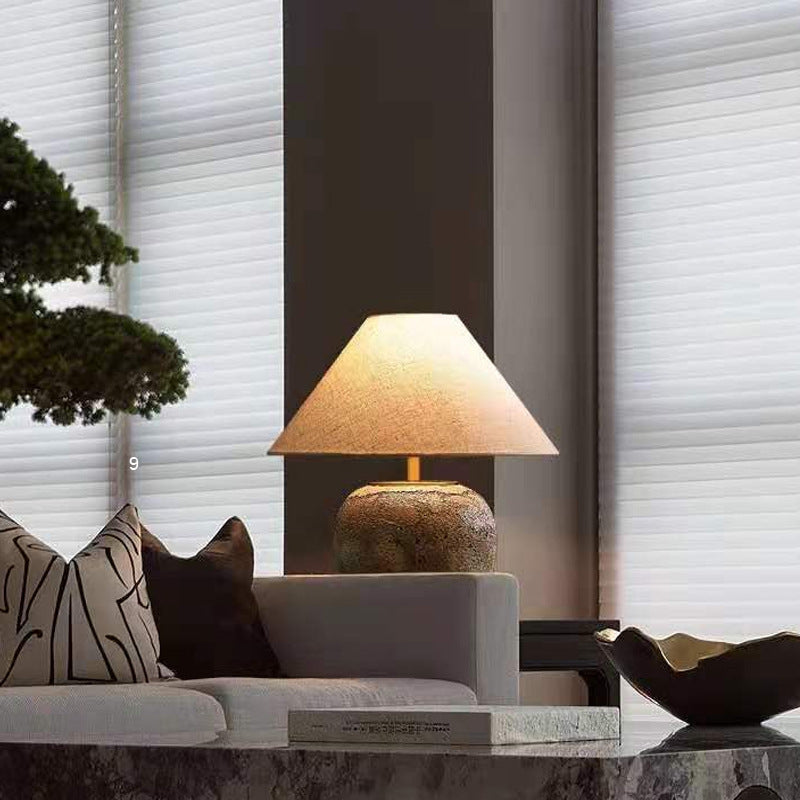 Elegant retro ceramic table lamp on a bedside table, showcasing its stylish design and warm glow.