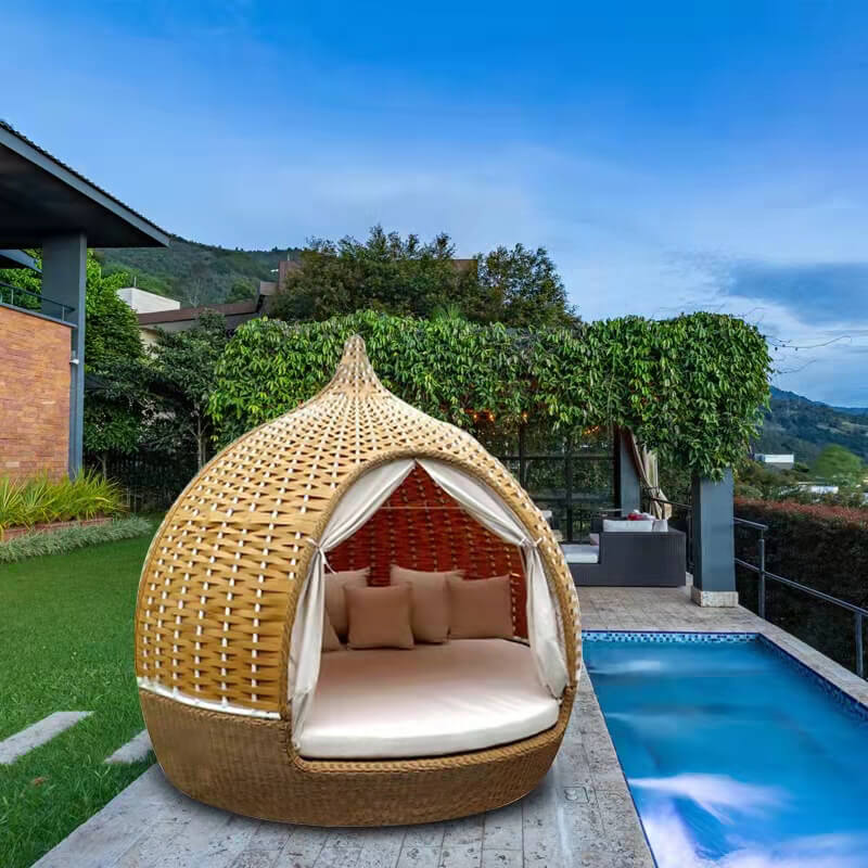 Close-up of the thick cushions on the rattan birdcage daybed sofa, highlighting comfort.