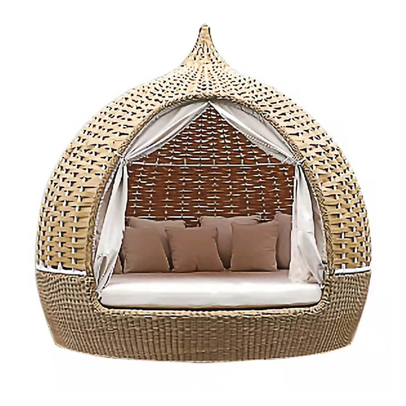 Rattan birdcage daybed sofa in a sunny garden, showcasing its elegant design.