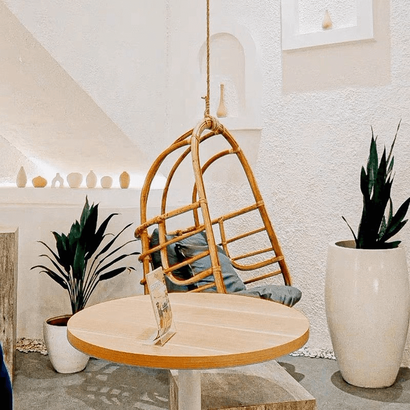 Rattan hanging chair set up in a garden, perfect for creating a cozy retreat.