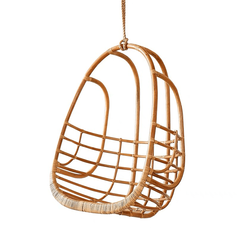 Close-up of the rattan chairs texture and cushion, ideal for outdoor lounging.