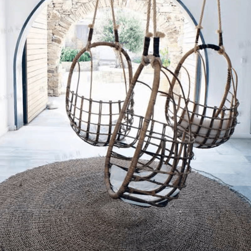 Rattan hanging chair set up in a garden, perfect for creating a cozy retreat.