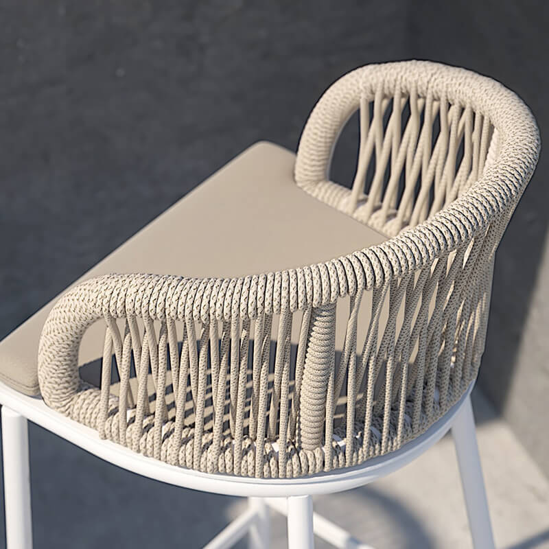 Elegant rattan high bar table set with aluminum legs in outdoor setting.