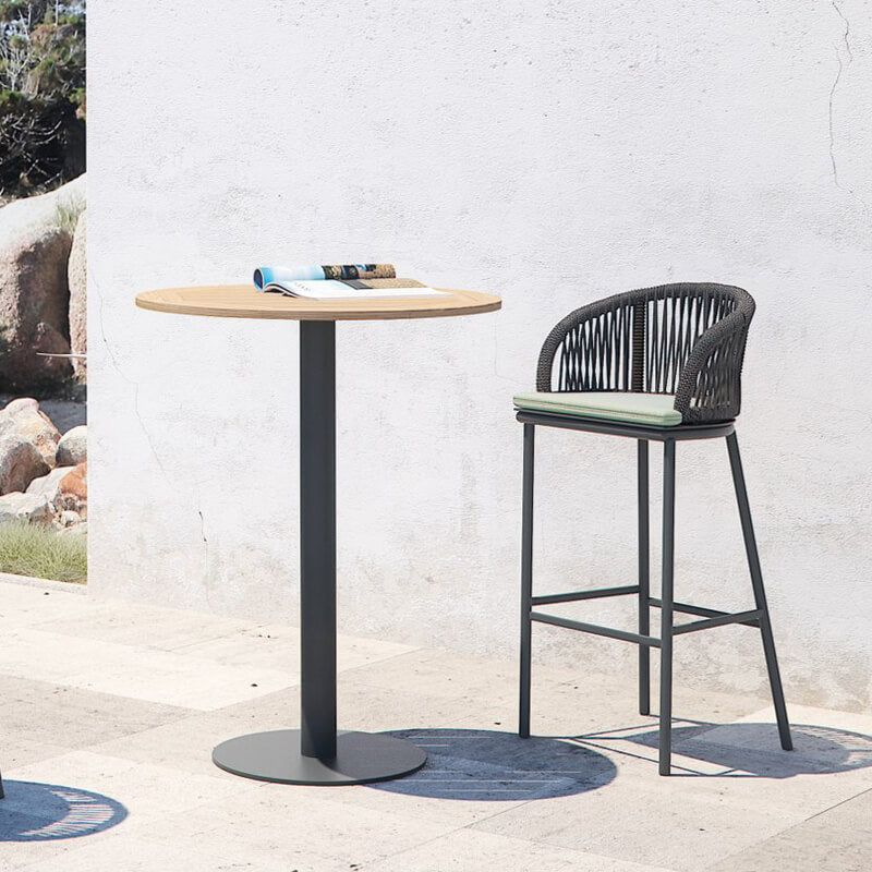 Full view of rattan high bar table set ready for outdoor dining.