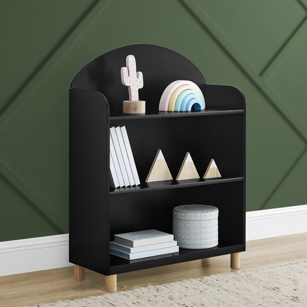 Reese Modern Kids Bookcase in a bright bedroom setting showcasing three shelves filled with colorful children's books.