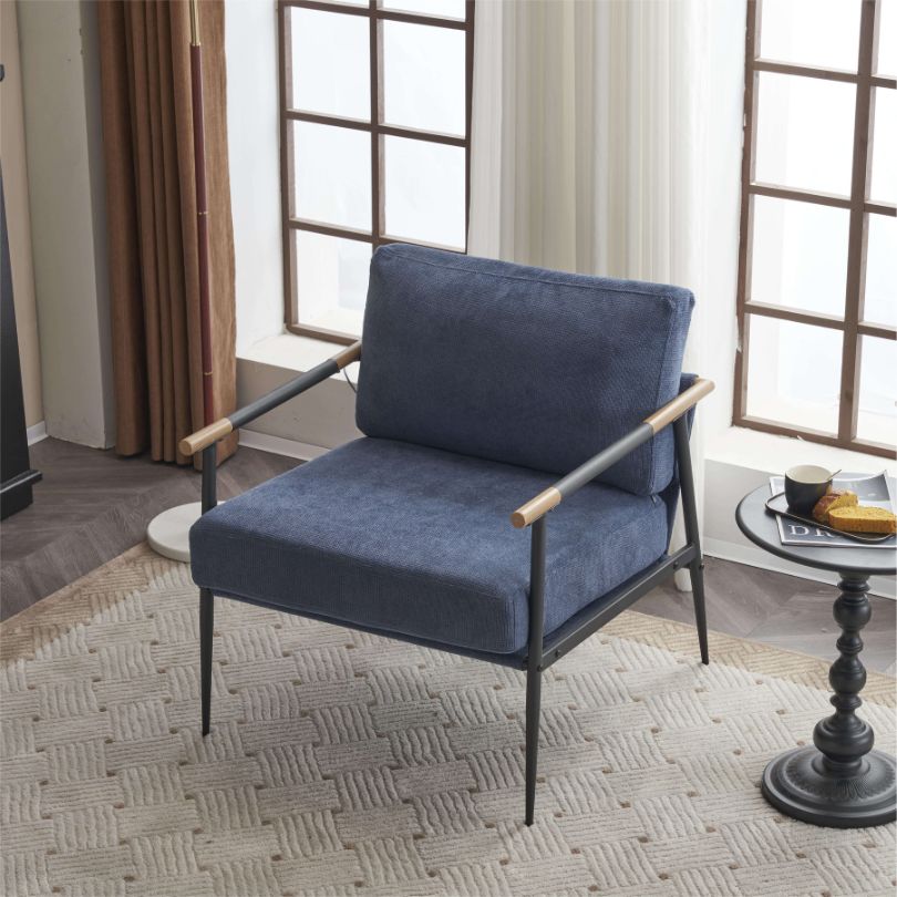 Side angle of the comfortable armchair with metal frame, highlighting its elegant design in a cozy living room setting.
