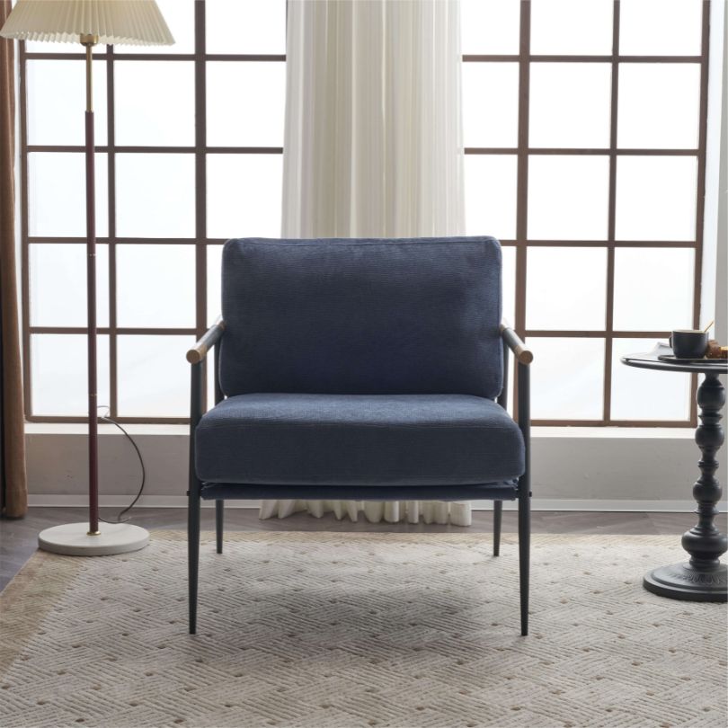 Front view of the vintage blue chenille armchair showcasing its soft padding and sleek black metal frame.
