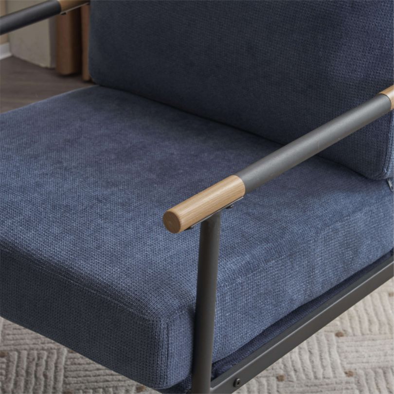 Close-up of the chenille fabric on the stylish blue armchair, demonstrating its plush texture and retro aesthetic.