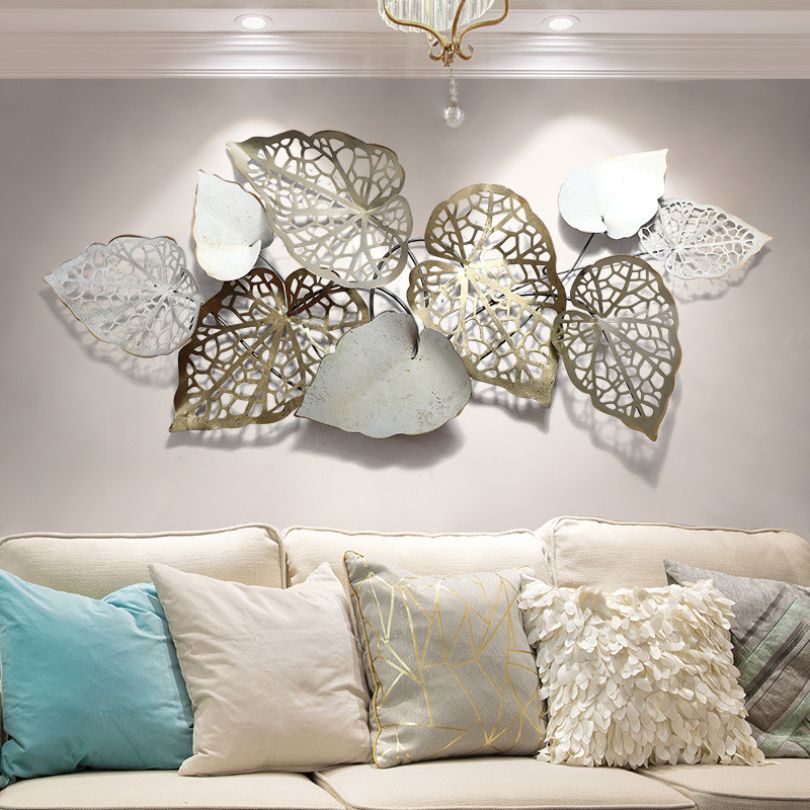 Installation process of the retro iron wall art, showing the built-in hook for easy hanging.