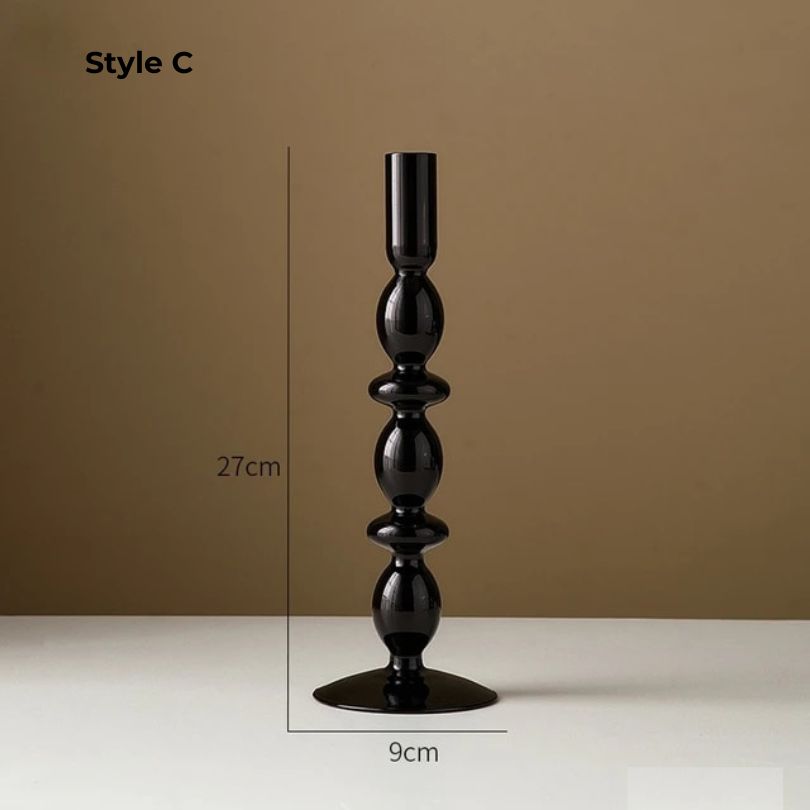 Stylish retro black glass candle holder with scented candle, adding elegance to home decor.