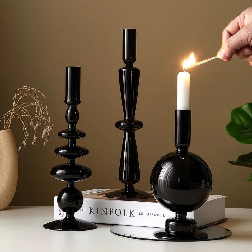 Elegant retro black glass candle holder on a beautifully set dinner table.