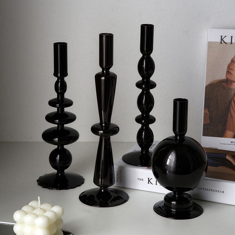 Stylish retro black glass candle holder with scented candle, adding elegance to home decor.
