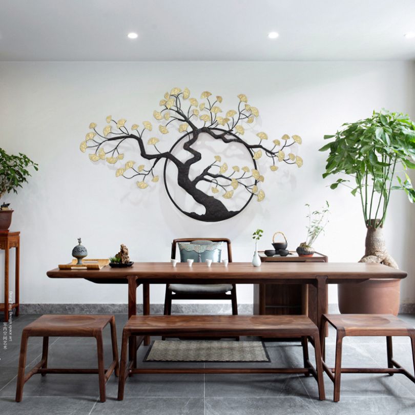 The metal tree wall art displayed in a cozy living room setting, adding a touch of sophistication.