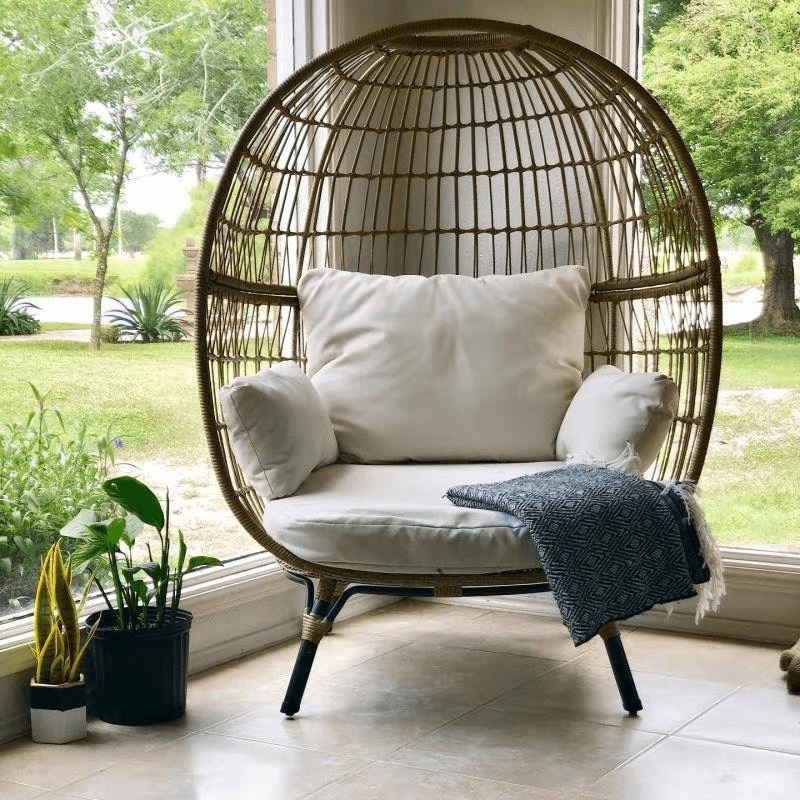 Side view of the Retro Ventura Outdoor Egg Chair with cushions in a sunny patio.