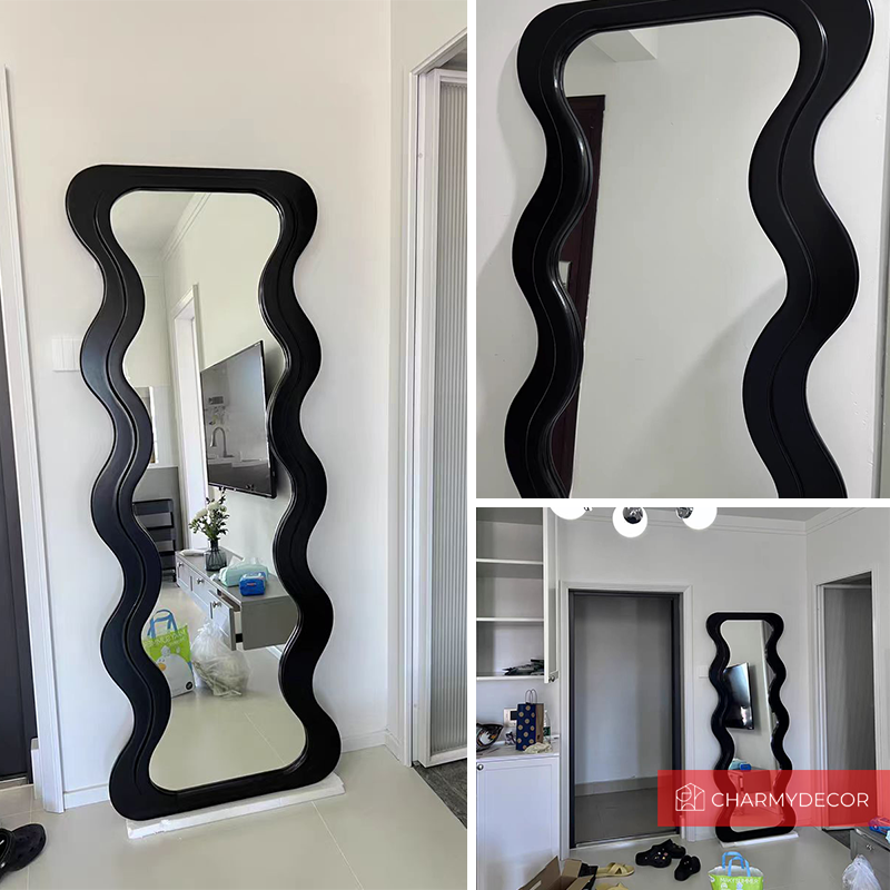 Full length mirror leaning against a wall in a minimalistic living room setting.