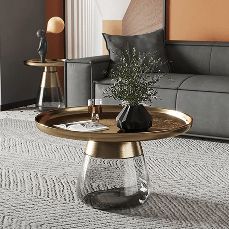 Modern round glass coffee table showcasing its clear surface in a contemporary living room.