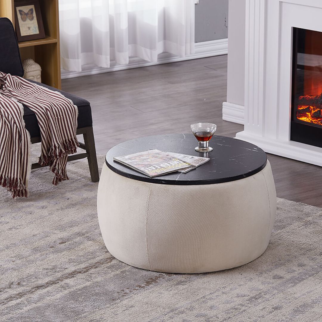 Beige round ottoman coffee table showcasing wooden lid and plush velvet upholstery.